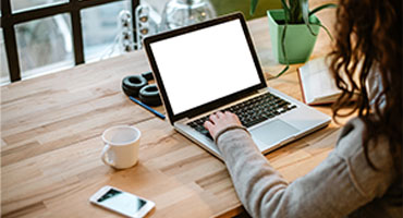 Woman typing at laptop